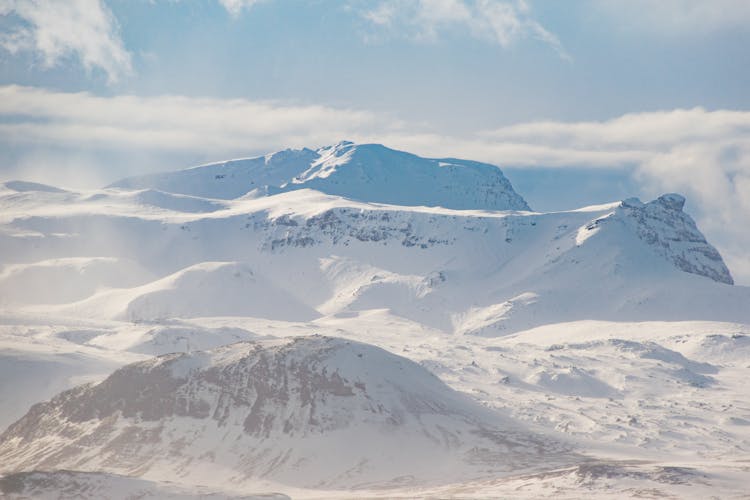 Snow Covered Mountain Ranges Under The White Skies