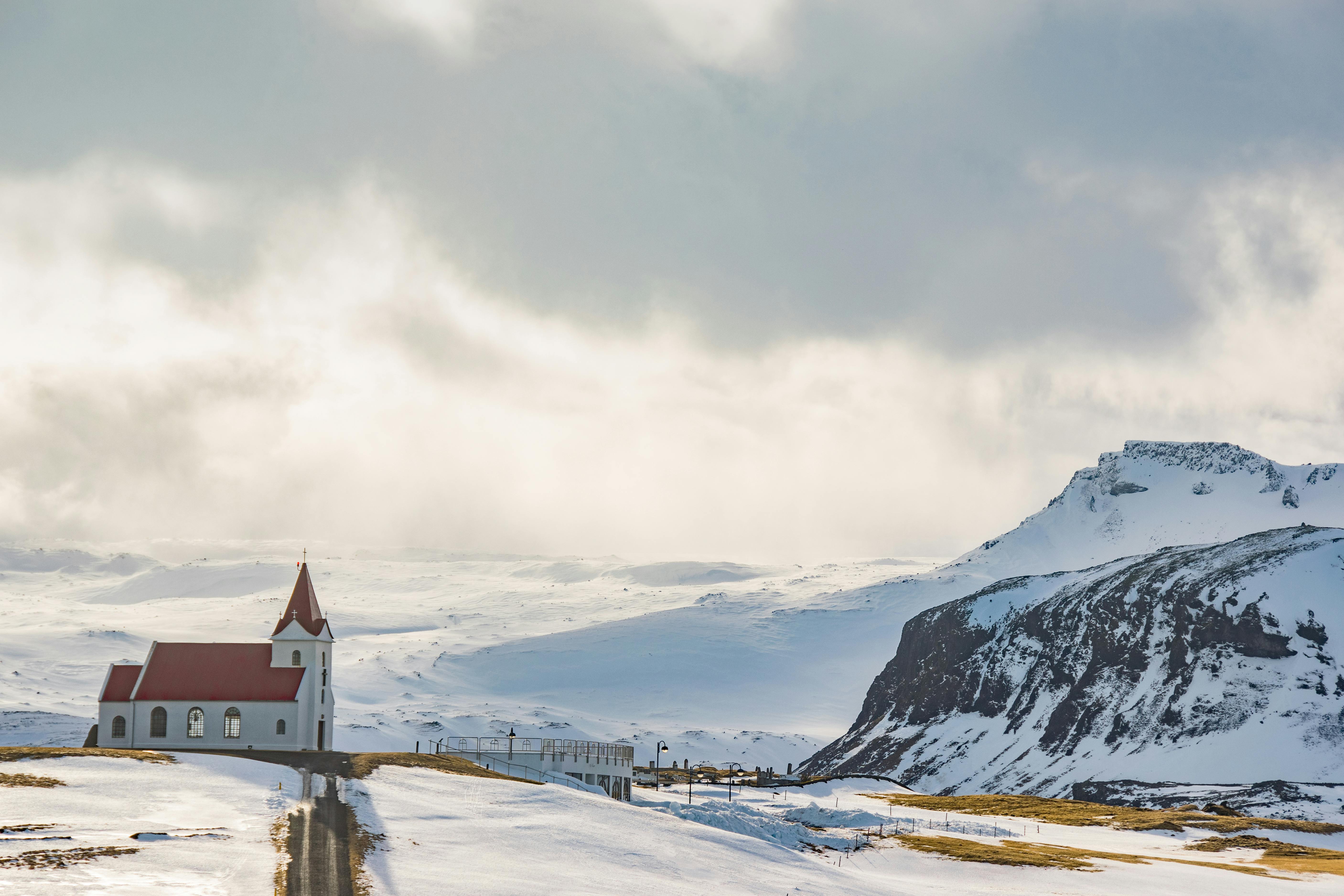 White Cathedral Near Mountain Covered With Snow · Free Stock Photo