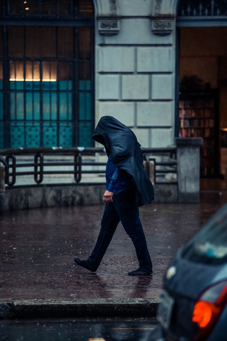 A Man Walking In The Rain