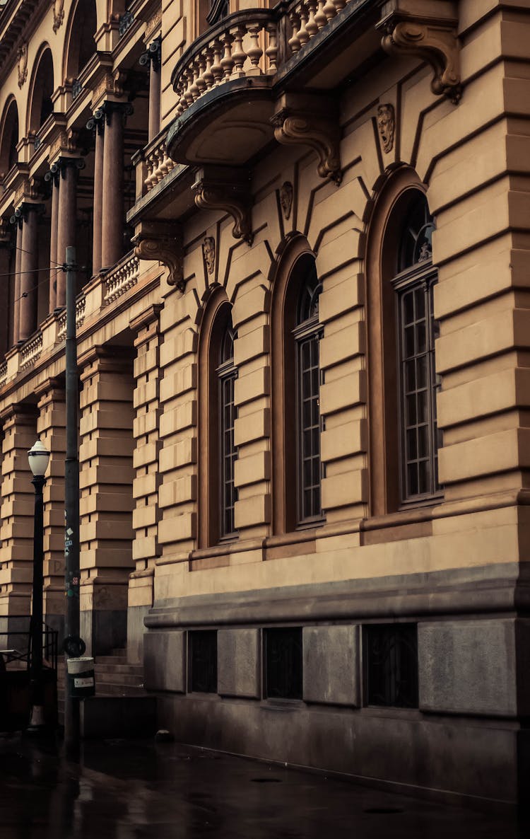 Brown Concrete Building With Arched Windows