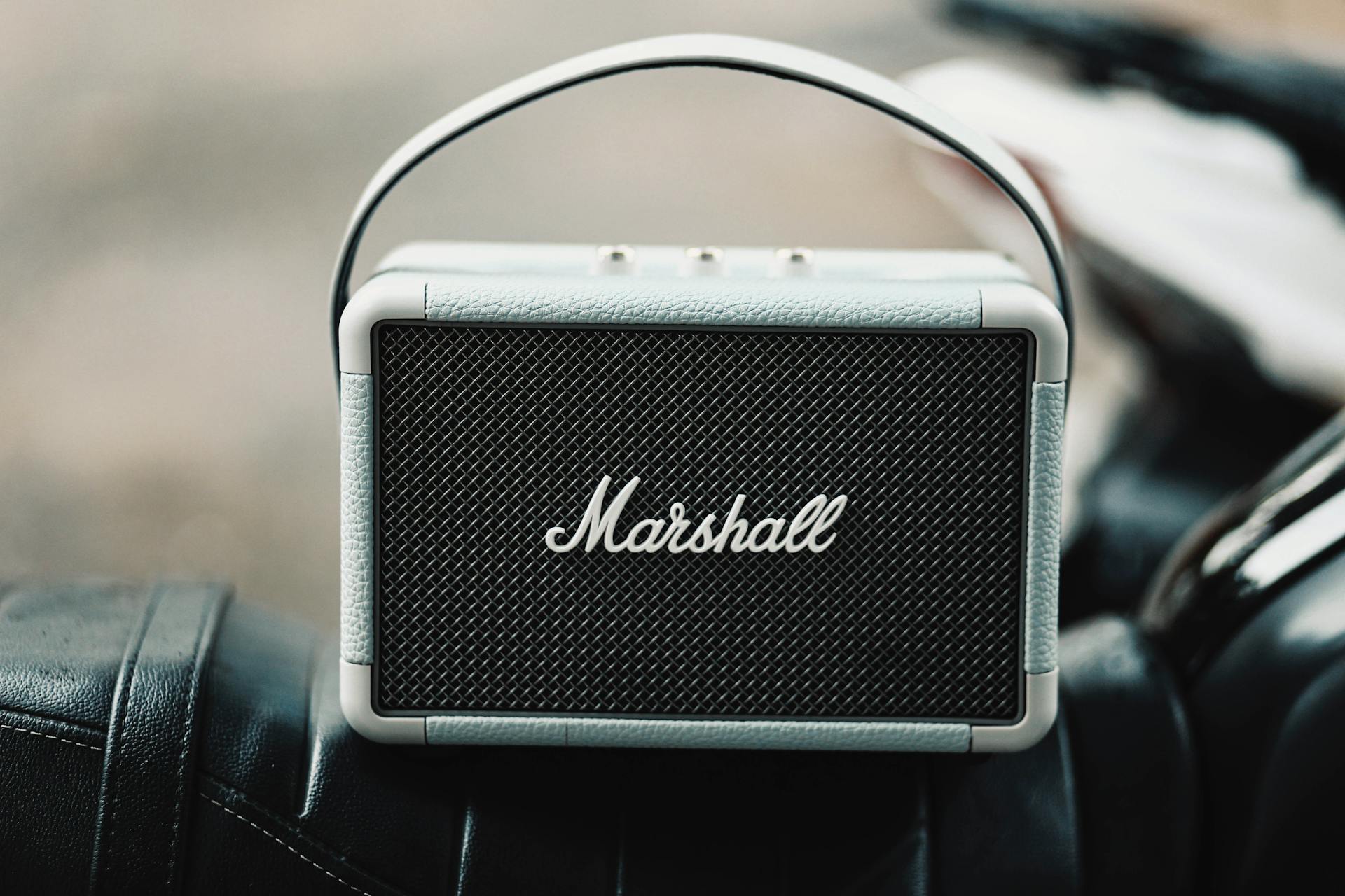 A sleek, portable Marshall wireless speaker with a leather finish.