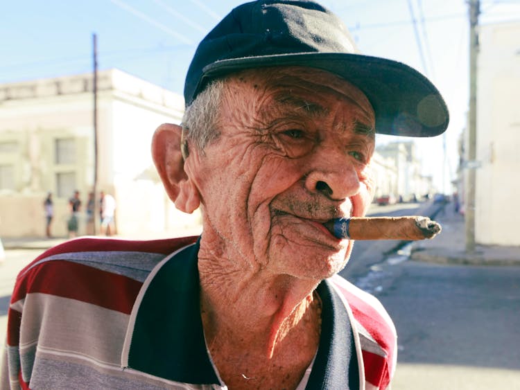 Man With Black Cap Smoking Tobacco