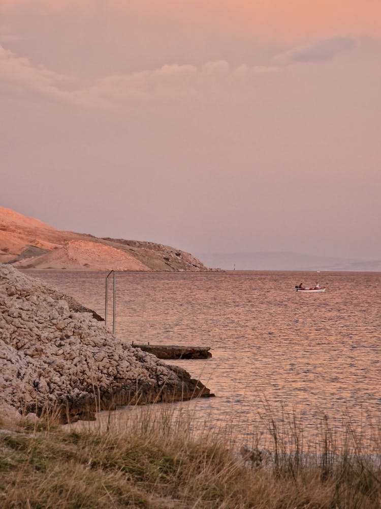 Boat On Water At Sunset