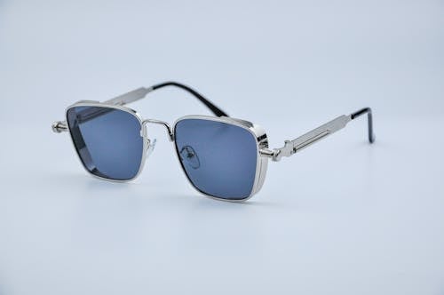 Steampunk Sunglasses with Blue Lens on White Surface