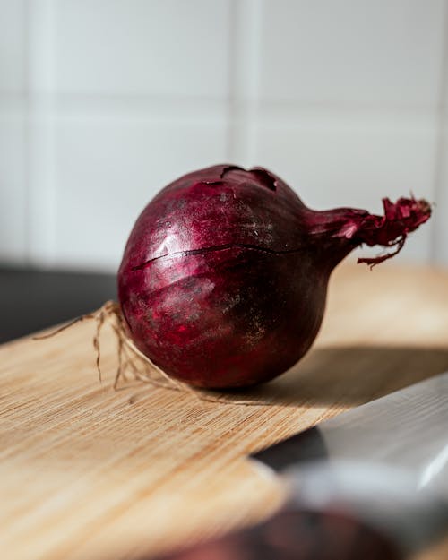 Red Onion on Wooden Chopping Board
