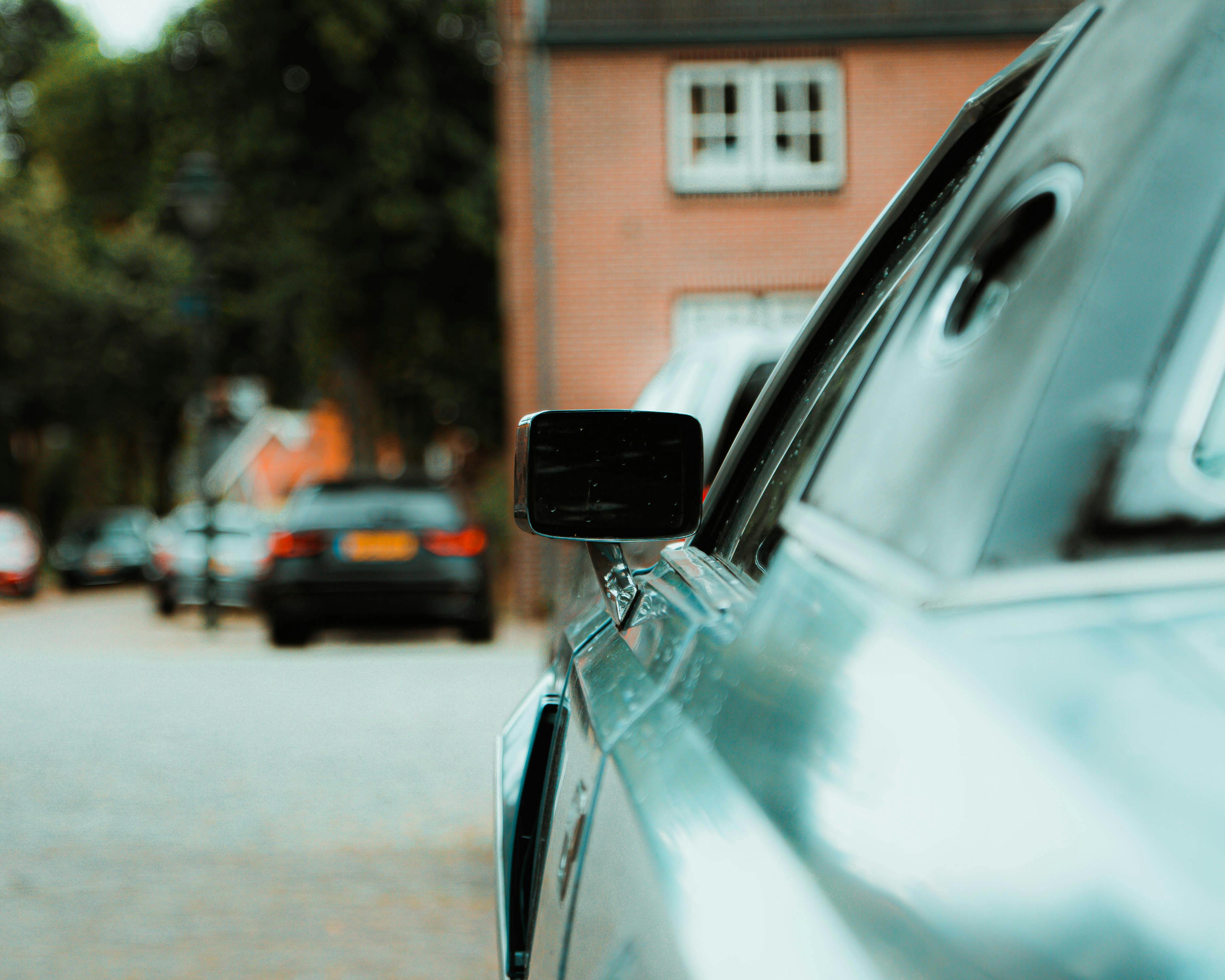 Side mirror of silver car showing professional surface finish
