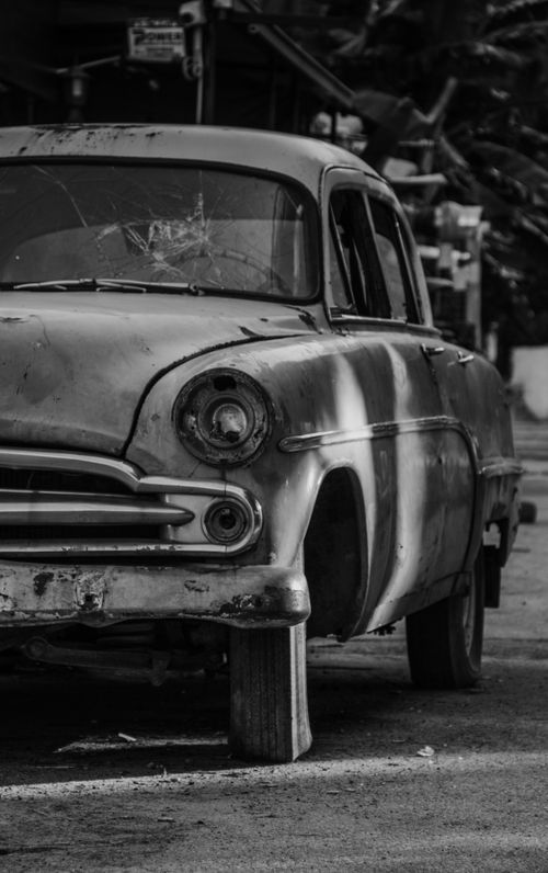 Free Close-up of a classic abandoned car in a monochrome setting, highlighting its rugged vintage beauty. Stock Photo