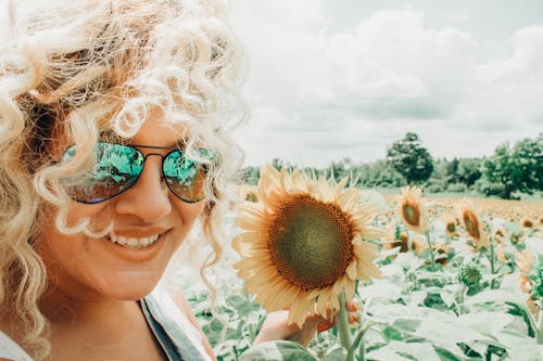 Free Smiling Woman Holding Sunflower Stock Photo