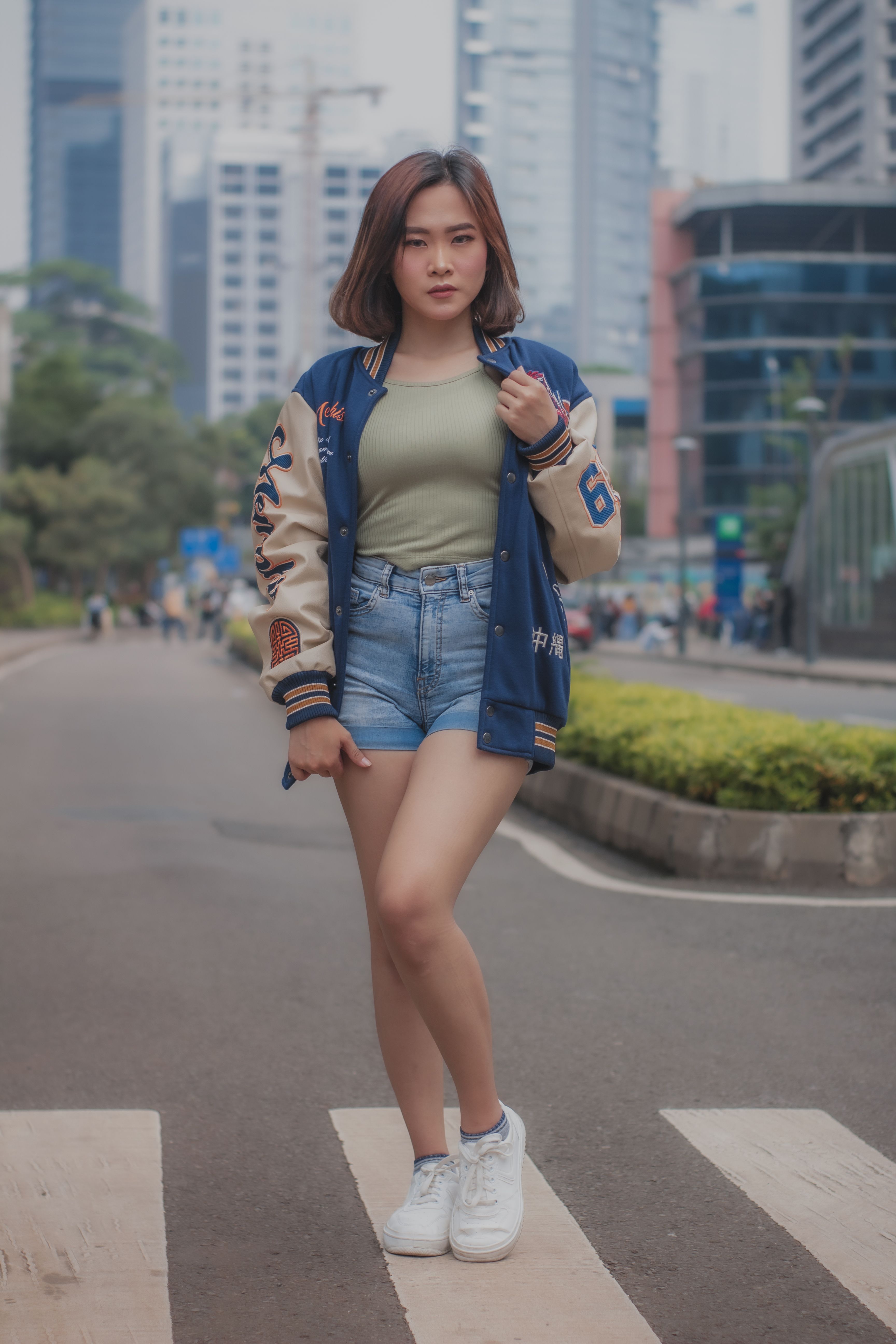 A Woman Wearing Denim Jacket and Denim Shorts · Free Stock Photo
