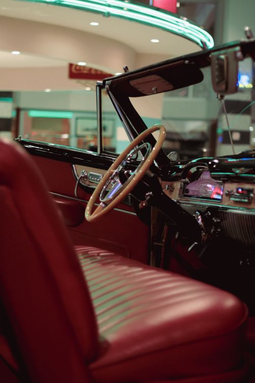 Free Close-up shot of a vintage cabriolet car's red leather interior at night. Stock Photo