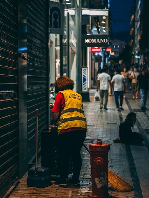 A Woman Cleaning the Street