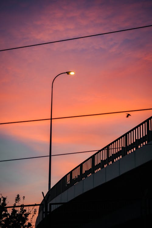 Silhouette of Street Lamp on Bridge at Sunset