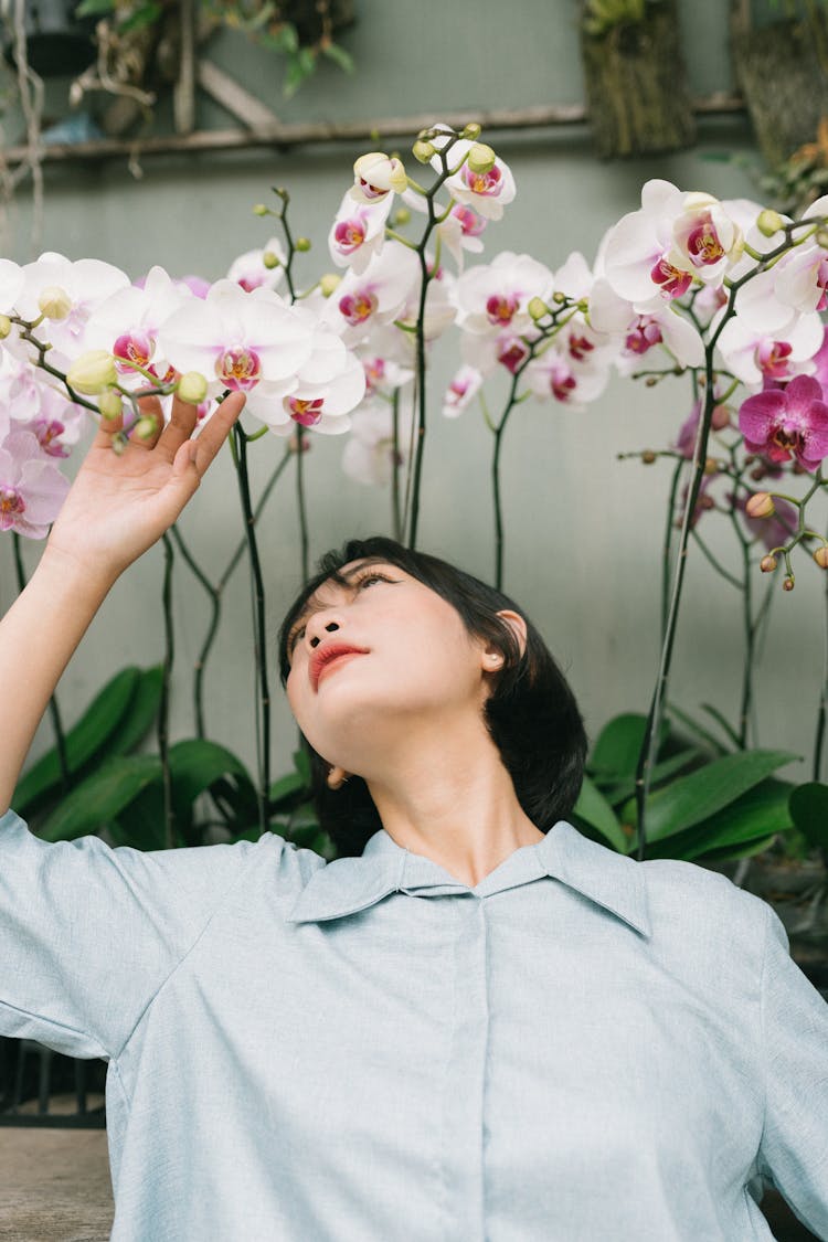 Photo Of Woman Touching Flowers