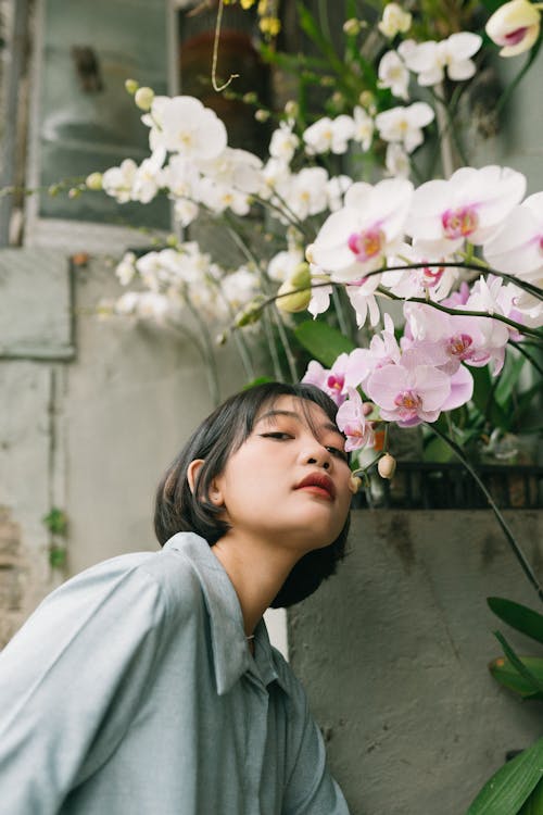 Girl Smelling Orchid Flower