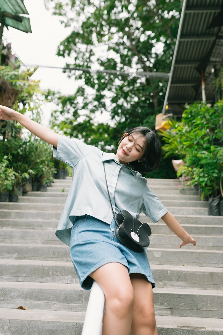 Woman Sliding On A Handrail