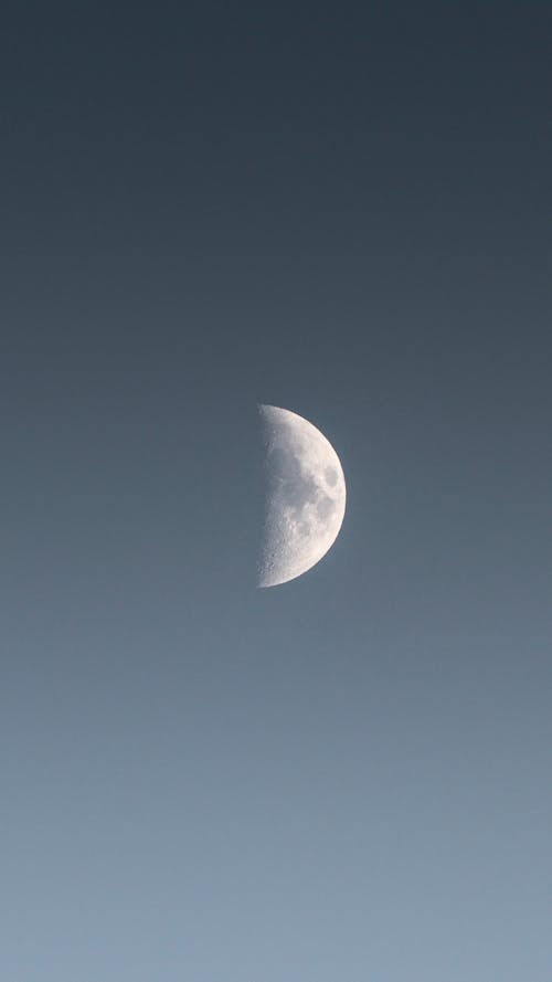 A Half Moon in the Grey Sky