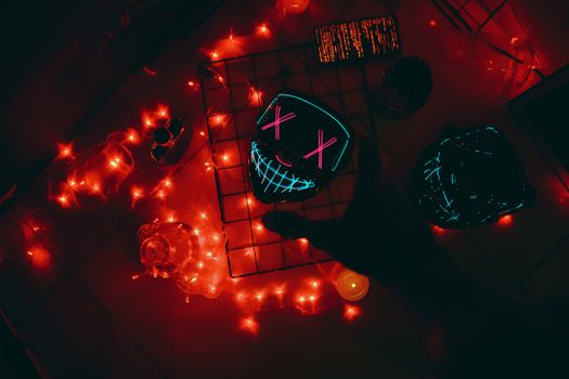 Vibrant party scene with neon glowing mask, red lights, and a dark silhouette creating a thrilling atmosphere.