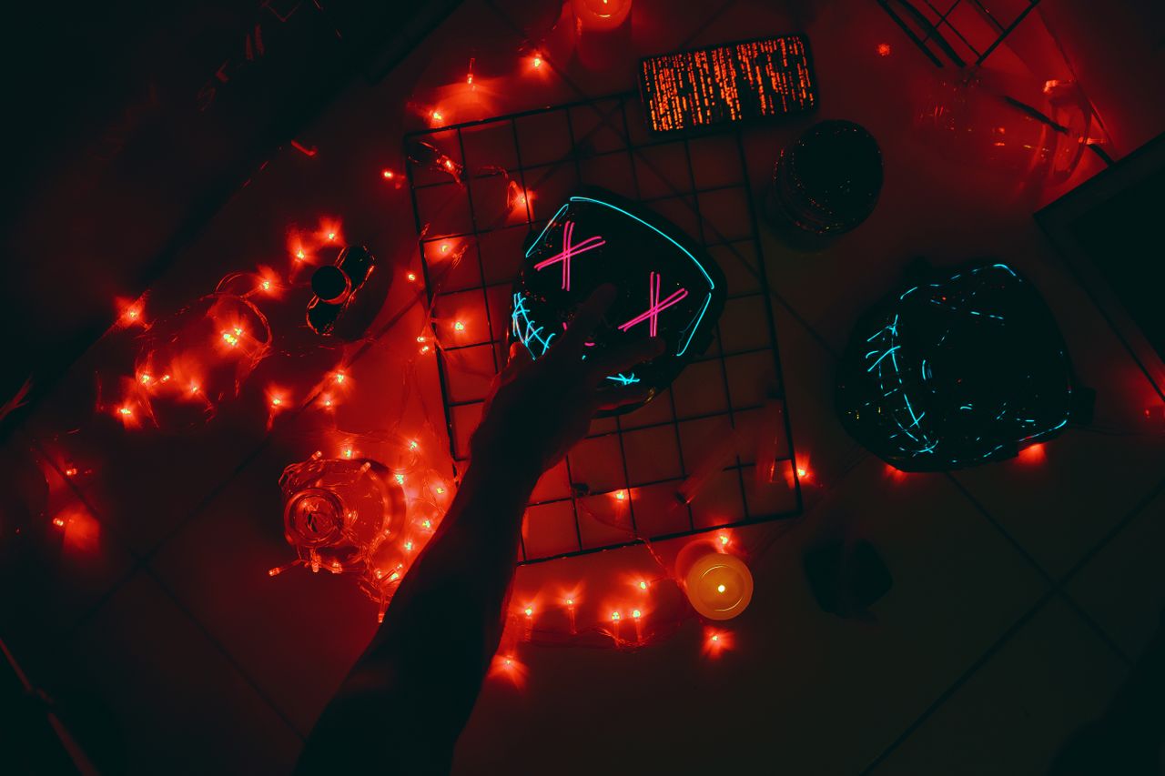 a neon mask with red lights creating a spooky eerie atmosphere viewed