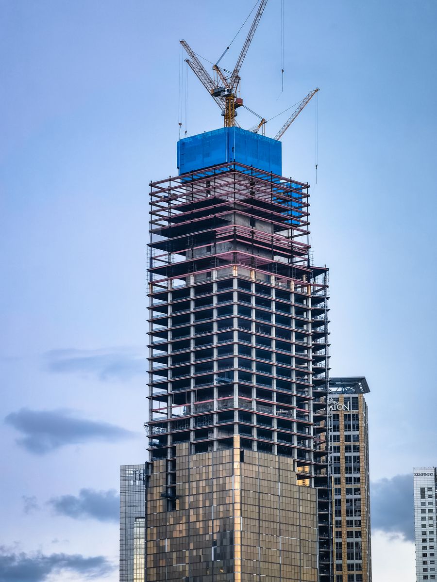 High-rise tower under construction with cranes