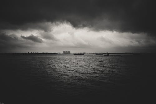 Grayscale Photo of Storm Clouds on Sea