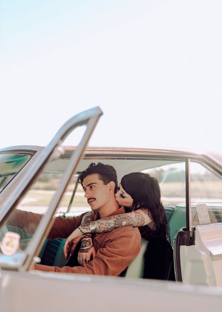 A Couple Sitting In The Car 