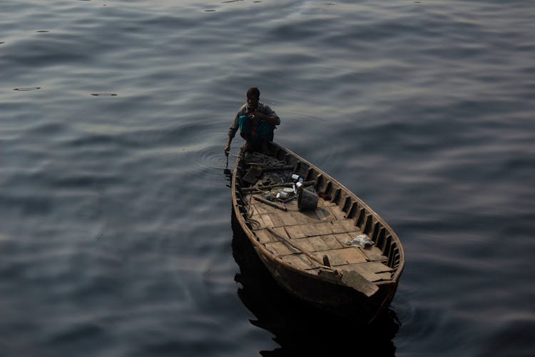 A Man Sitting On A Boat