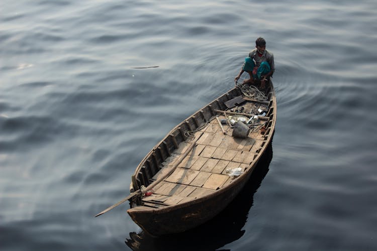 A Man Sitting On A Boat