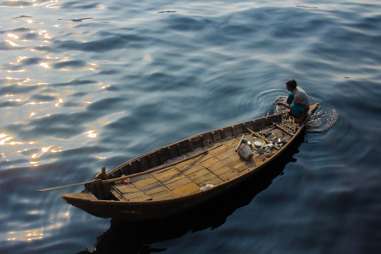 A Man Fishing On A Boat