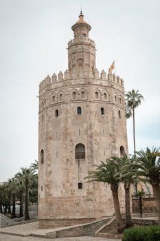 The Torre del Oro watchtower in Seville, Spain, showcases medieval architecture.
