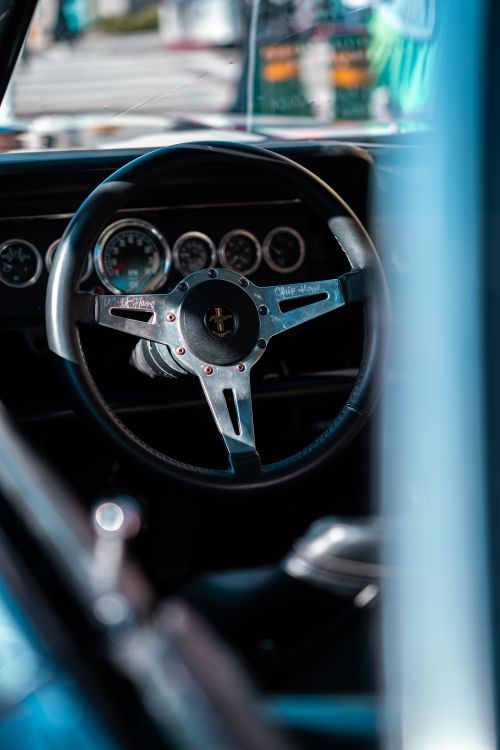 Free Detailed shot of a vintage car steering wheel with gauges visible, Monterey, CA. Stock Photo