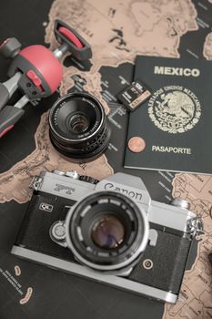 A vintage camera, passport, map, and travel accessories set the scene for an adventure.