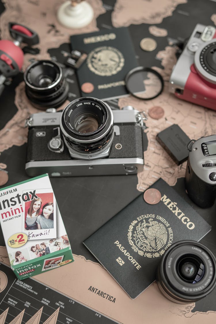 Camera, Passports And Lenses On A Table