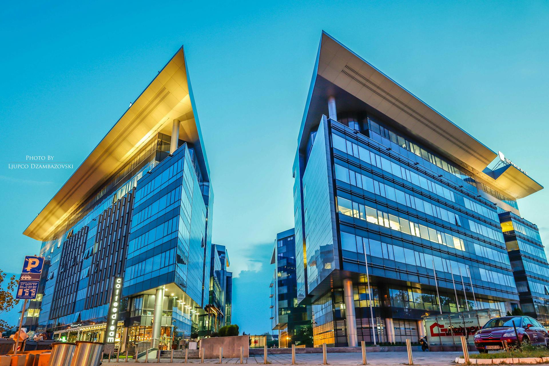 Futuristic glass office buildings at sunset in an urban area, conveying modern business architecture.