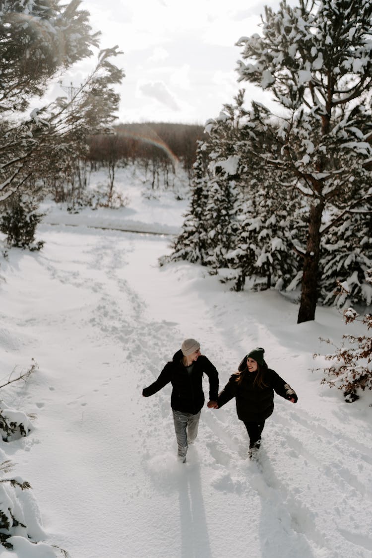 Couple Running In Winter Forest