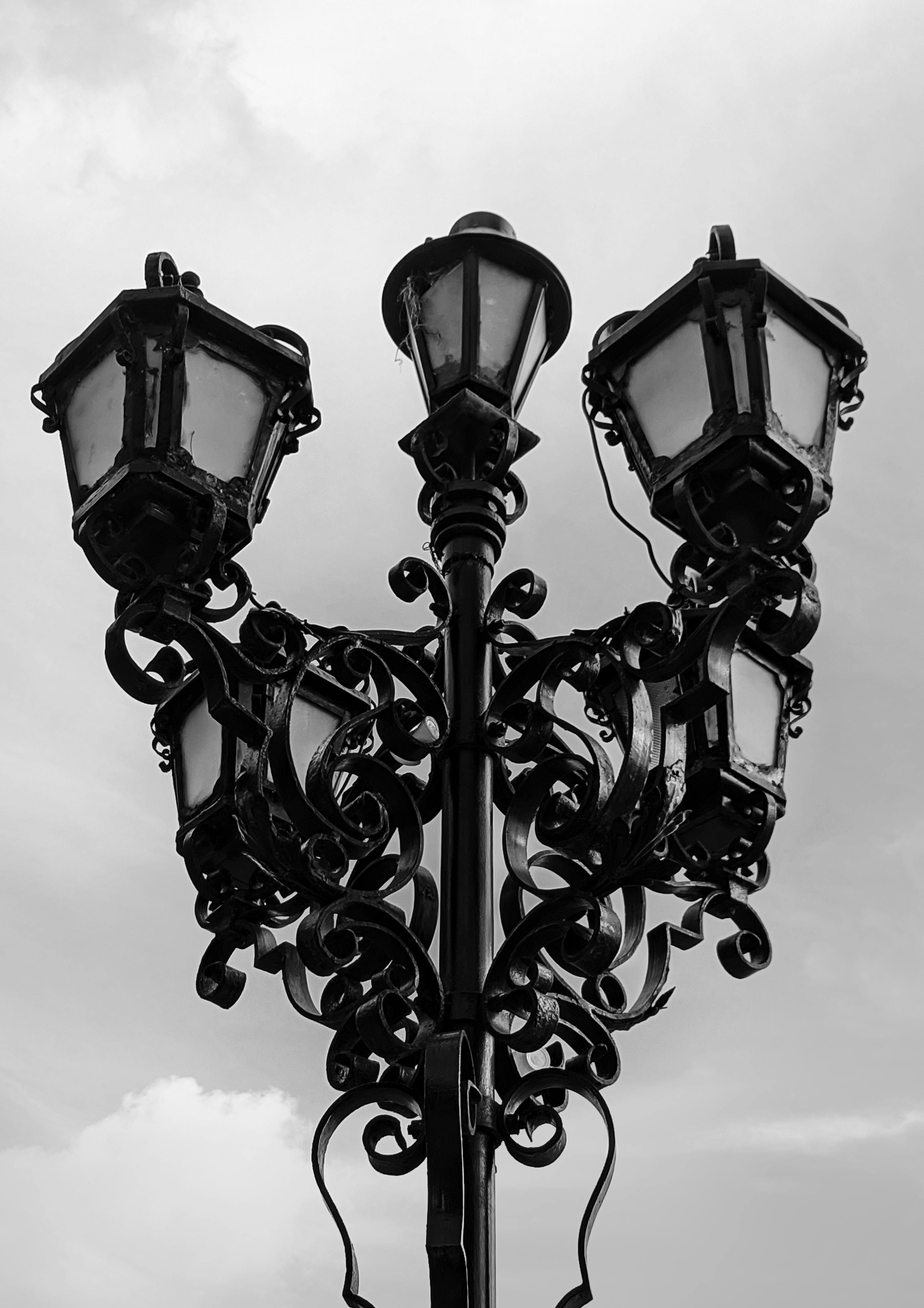 Grayscale Photo of a Sidewalk Near Lighted Street Lamps · Free Stock Photo