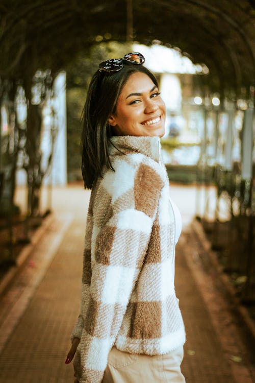 A Woman Smiling Wearing Fur Jacket 