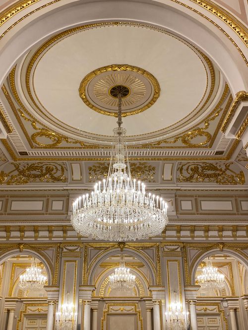 Free Stunning ceiling view with luxurious chandeliers and golden decor in Kyiv, Ukraine. Stock Photo