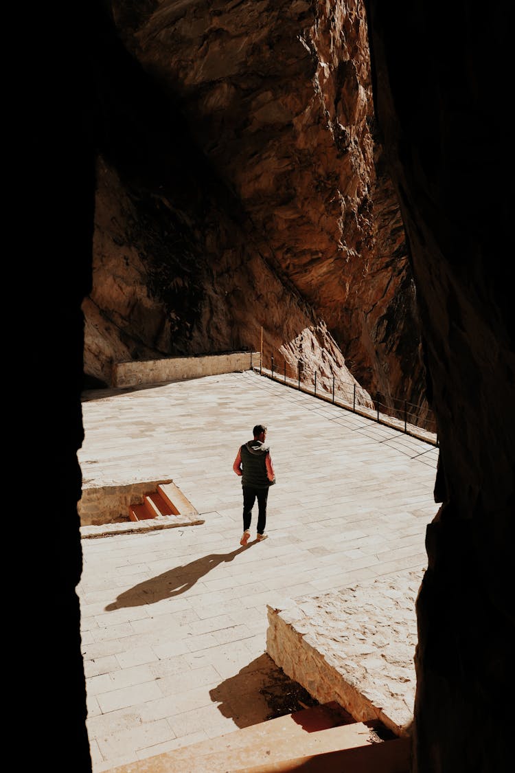 Man Walking In Ancient City Ruins