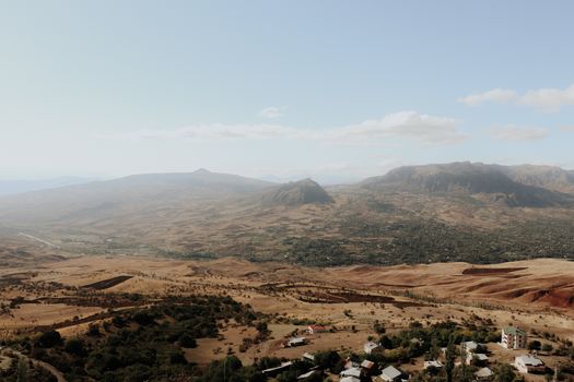 A scenic view of a vast mountain range under a clear blue sky, perfect for nature enthusiasts.