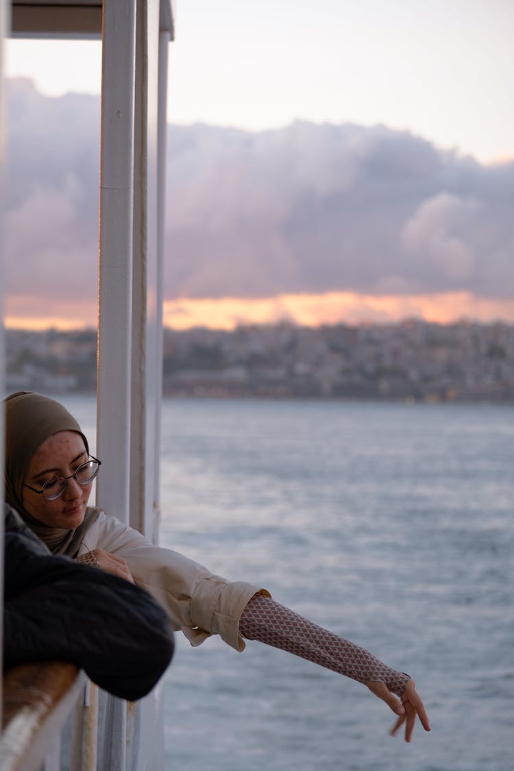 Woman Reaching Above The Railing