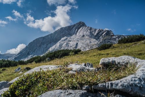 Free Explore the majestic mountain landscape under a clear blue sky, featuring lush greenery and rugged terrain. Stock Photo