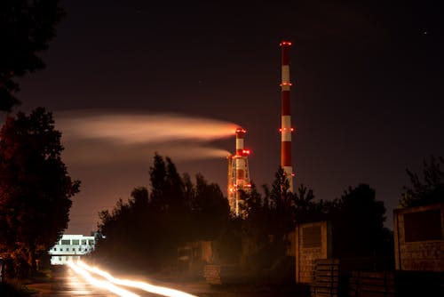 Factory Chimneys over Road at Night