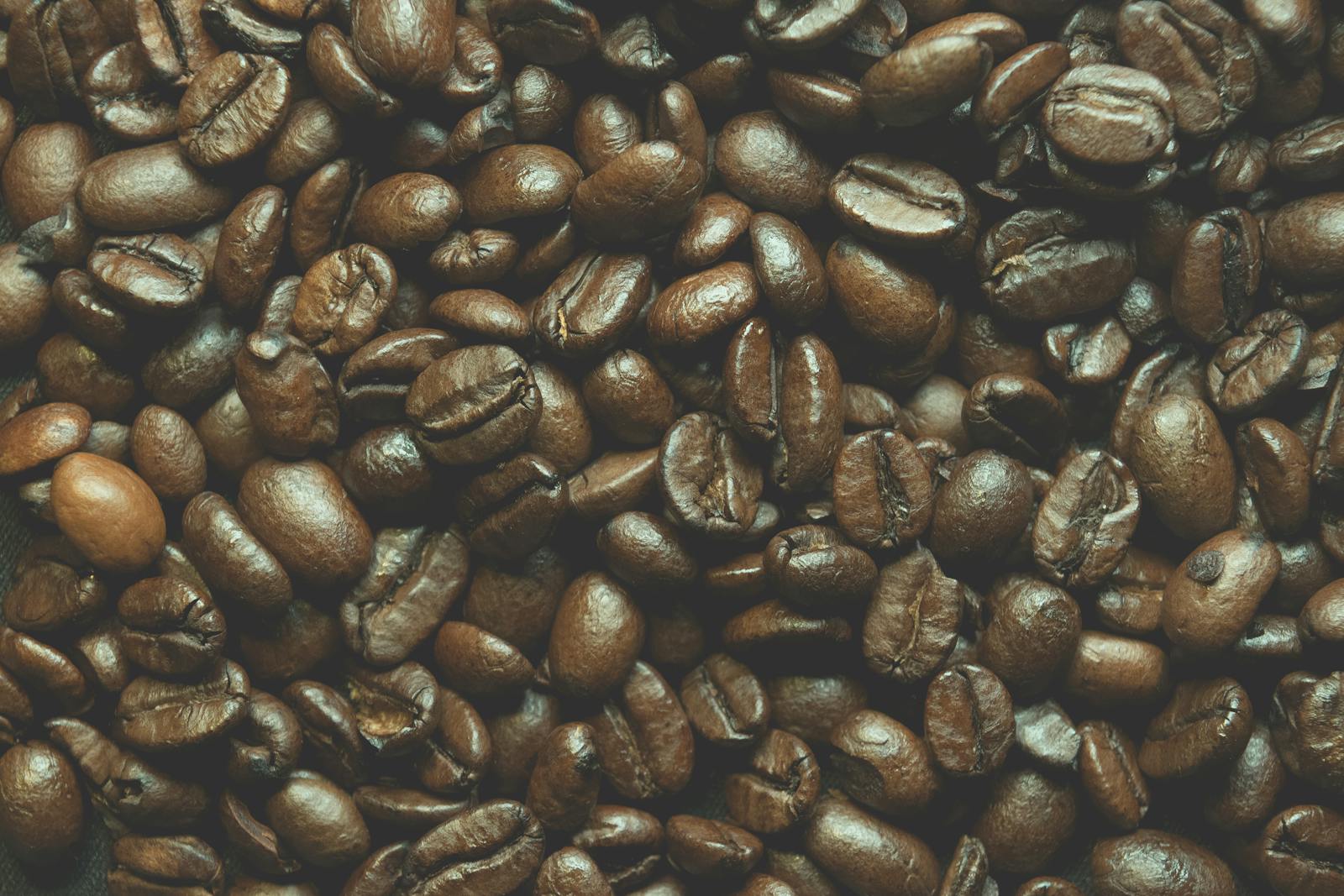 Close-up of roasted coffee beans showing varied textures and sheen