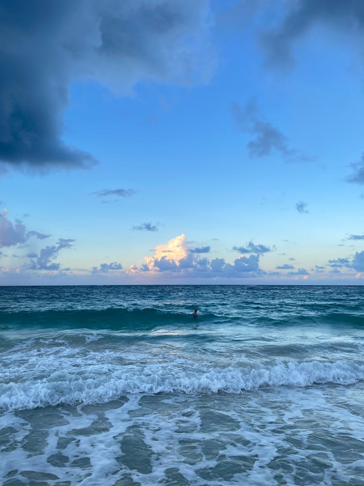 Person Swimming On Ocean Waves