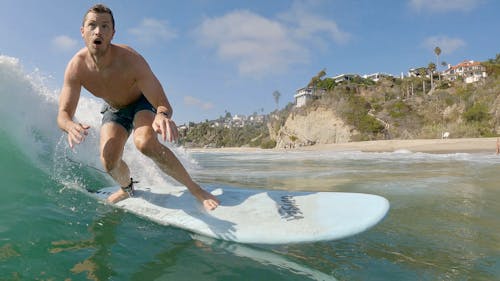 Photo of a Man Surfboarding