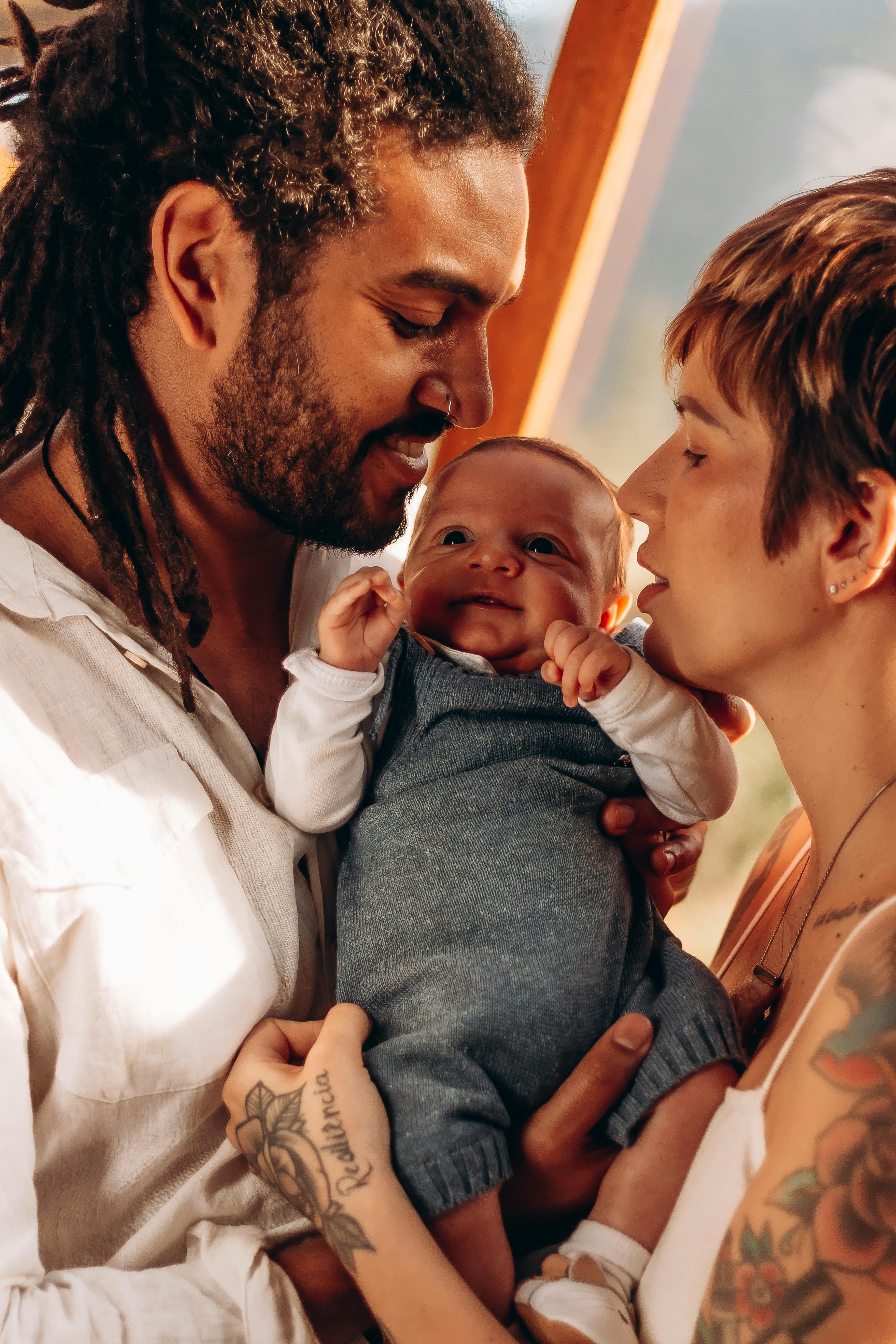 man and woman holding a smiling baby