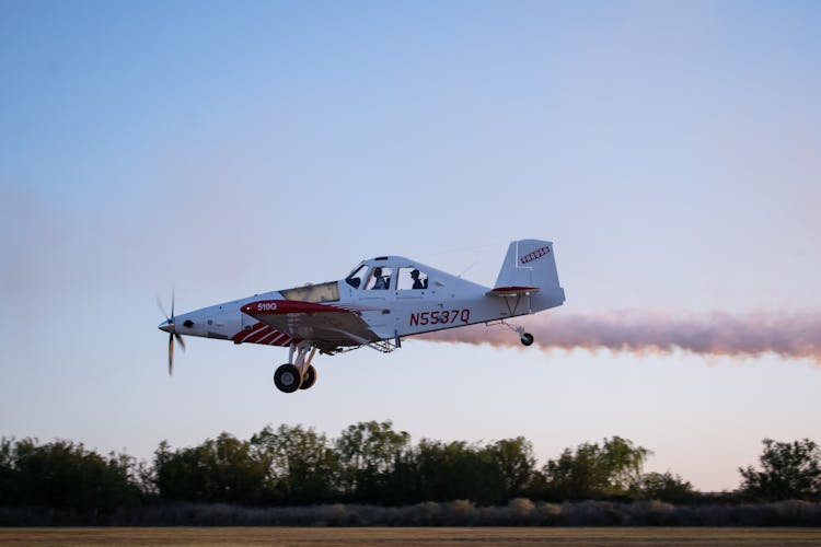 Airplane Landing On Brown Grass