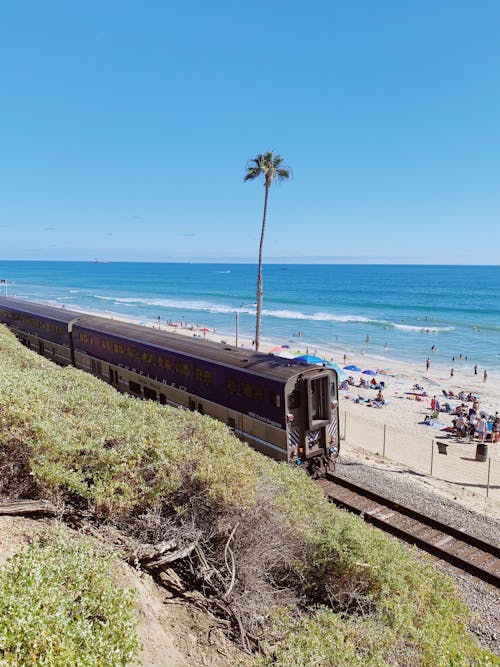A Moving Train on Track Beside the Beach
