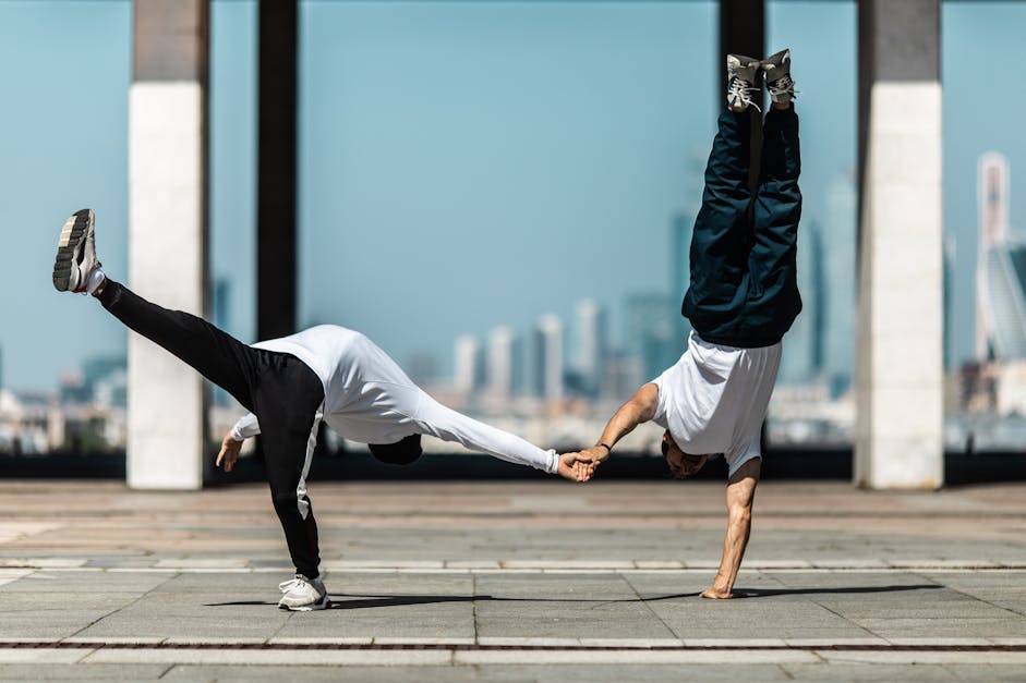 People Holding Each Others Hand while Doing Breakdance · Free Stock Photo