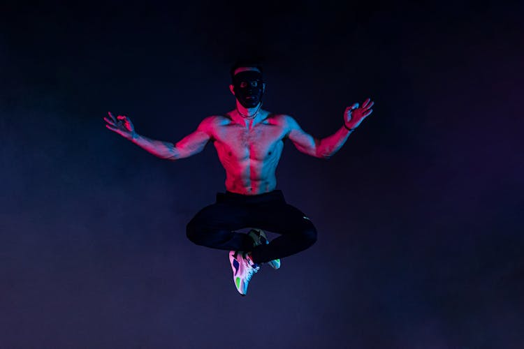 A Topless Man Jumping In The Air